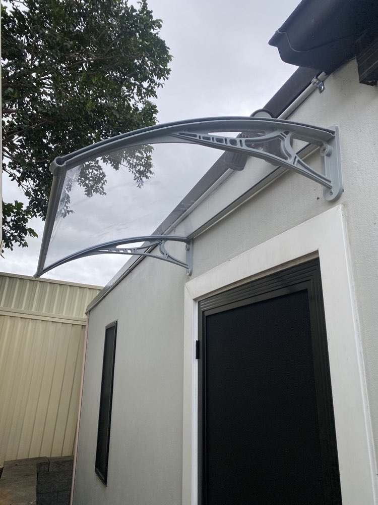 New polycarbonate awning installed above a doorway