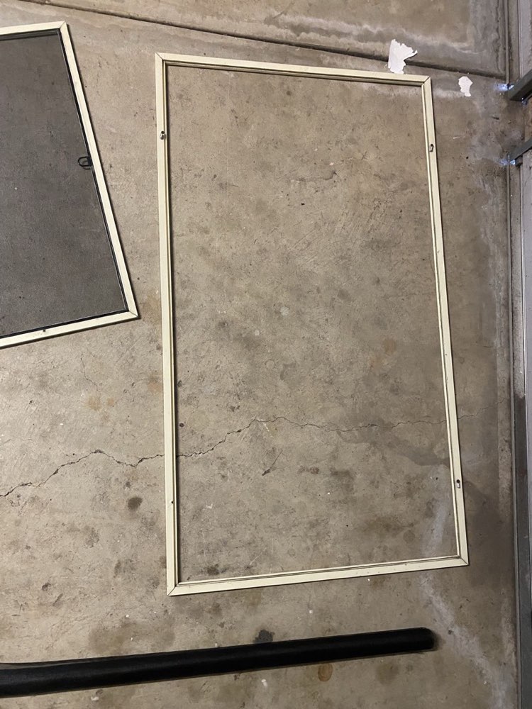 Flyscreen frame with damaged mesh removed — before