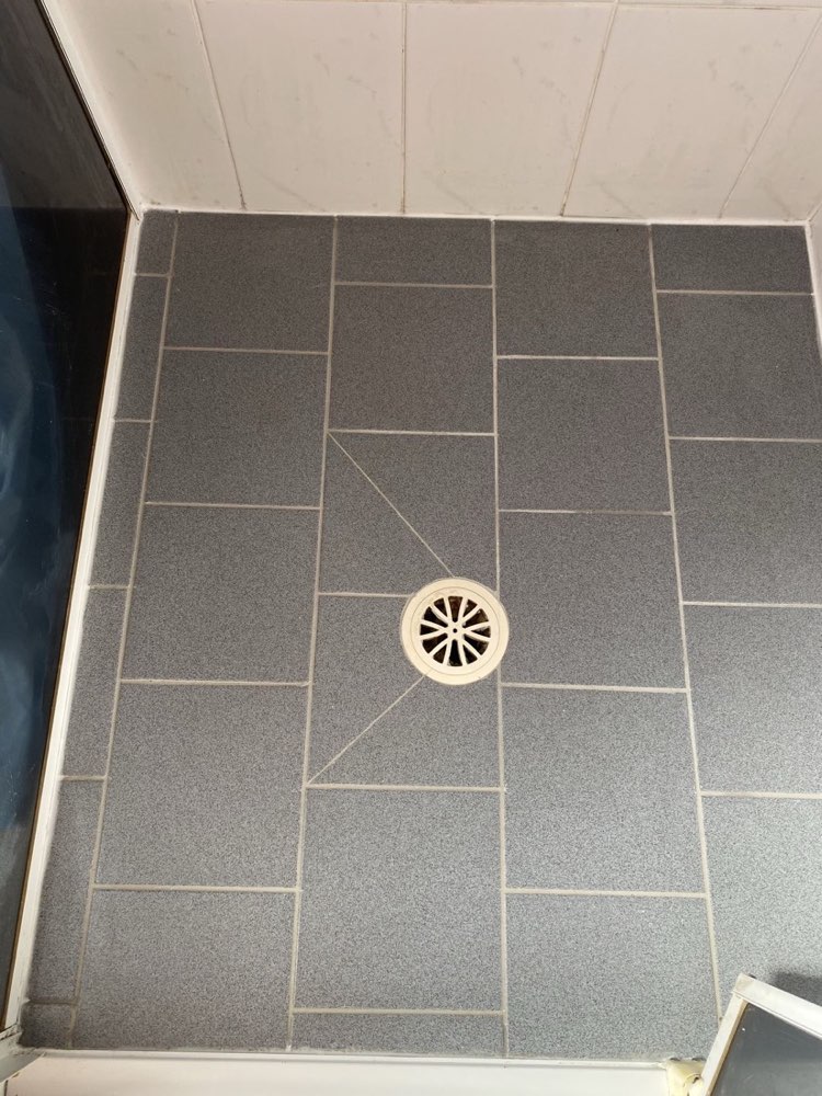 Shower floor with fresh grout and sealant — after