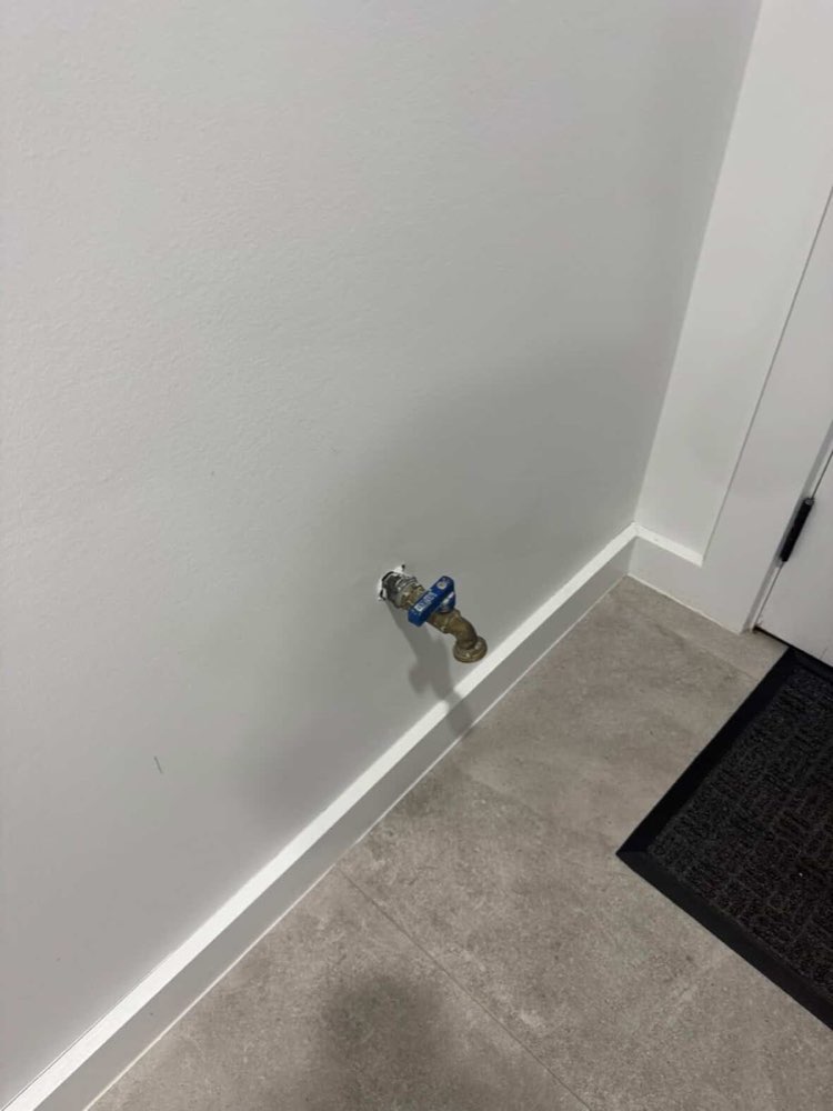 Unused tap fitting on an internal wall — before
